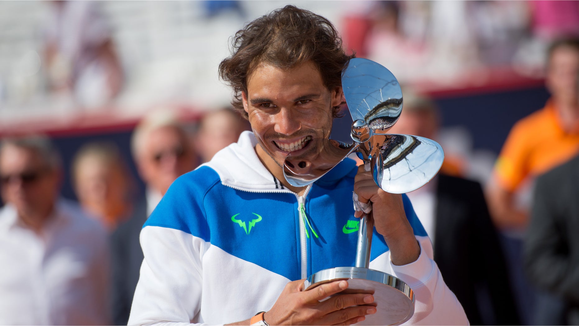 Spain's Rafael Nadal celebrates with the trophy after he won the final match of the Hamburg Open ATP tennis tournament against Fabio Fognini of Italy, in Hamburg, Germany, Sunday Aug. 2, 2015. (Daniel Reinhardt/dpa via AP)