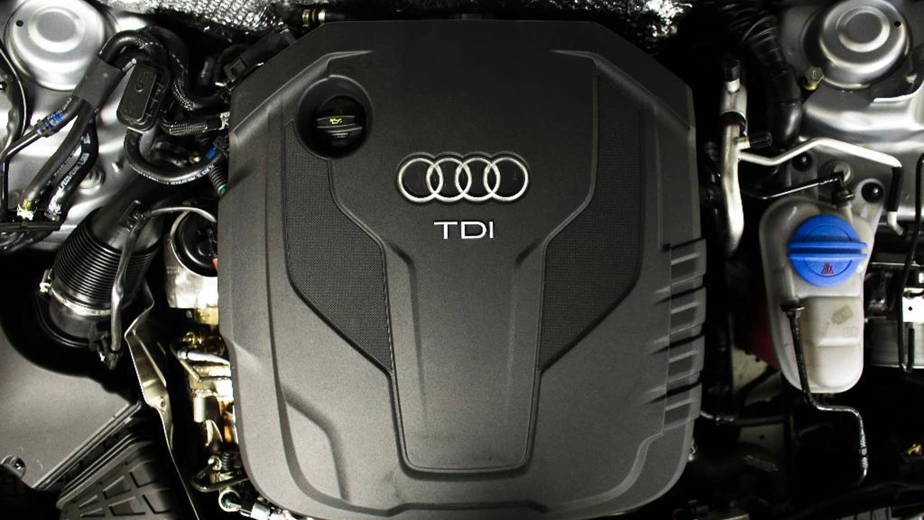 The sign of German car company Audi is attached on the engine of a TDI, a turbo diesel model, in Berlin, Germany, Monday, Sept. 28, 2015. Volkswagen AG's upmarket Audi brand said 2.1 million of its vehicles are among those with the engines affected by the emissions-rigging scandal. (AP Photo/Markus Schreiber)