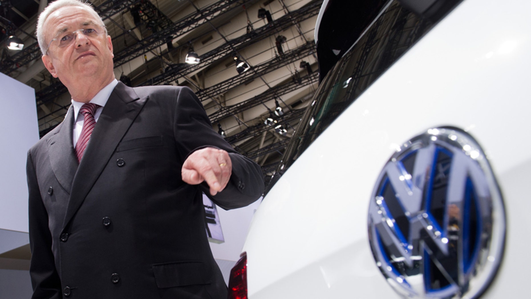 FILE In this May 13, 2014 file picture then Volkswagen CEO , Martin Winterkorn, stands next to a VW car at the annual shareholder meeting in Hannover, Germany. German prosecutors said Monday June 20, 2016 they have opened an investigation of former Volkswagen CEO Martin Winterkorn on allegations of market manipulation in connection with the company's scandal over cars rigged to cheat on U.S. diesel emissions tests. ( Julian Stratenschulte/dpa via AP,file)