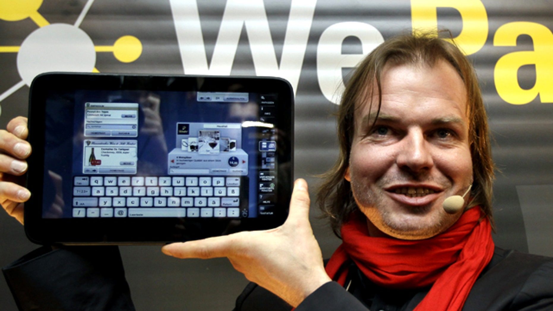 Helmut Hoffer von Ankershoffen, Managing Director of the Neofonie company poses with the new 'WePad' tablet PC during a news conference in Berlin, Germany, Monday April 12, 2010. The German maker of a new tablet computer is setting out to rival Apple's iPad with the promise of even more sophisticated technology.
