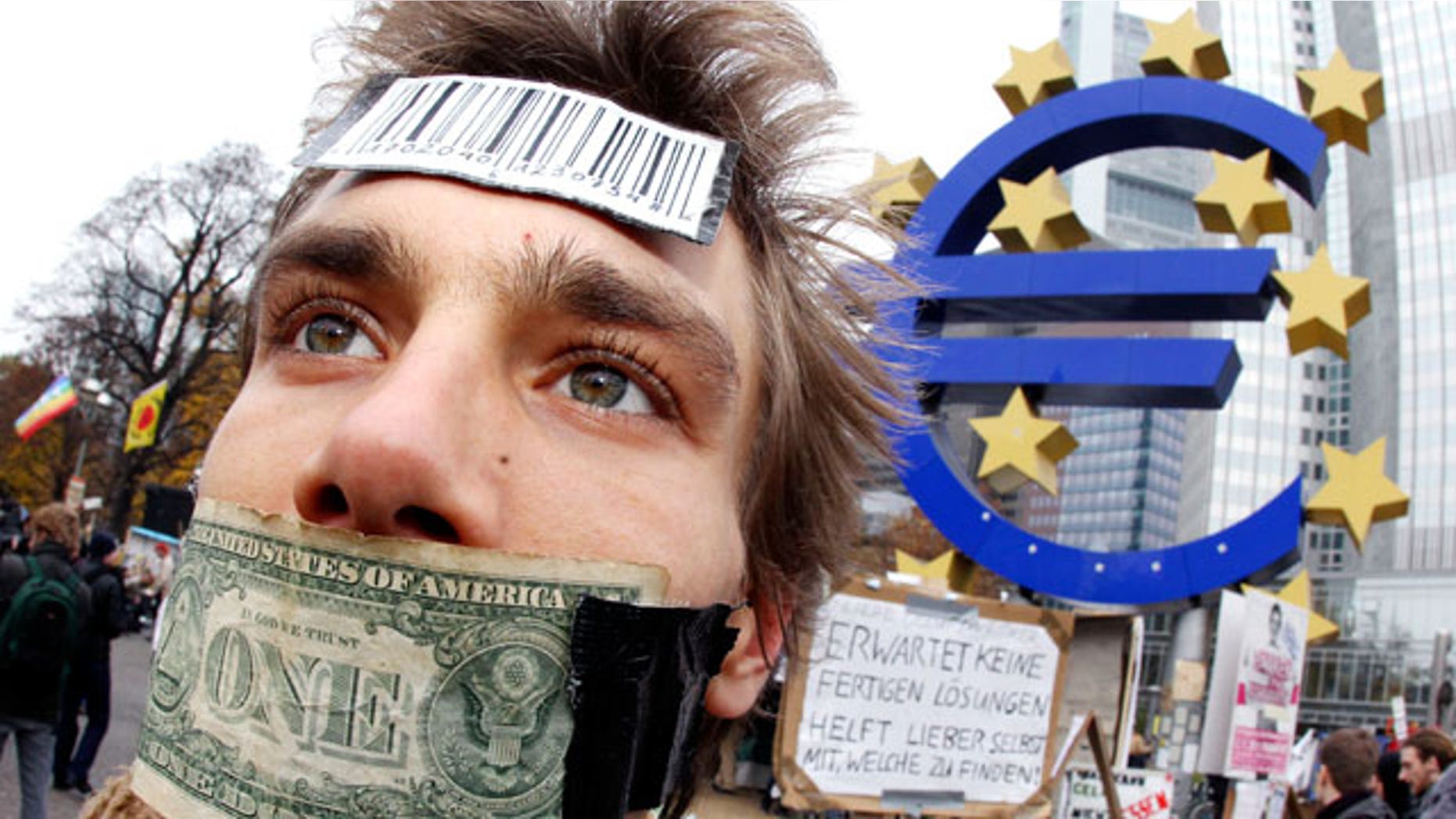 Nov. 12, 2011: A demonstrator has taped his mouth with a dollar bill in front of the European Central Bank in Frankfurt, Germany.