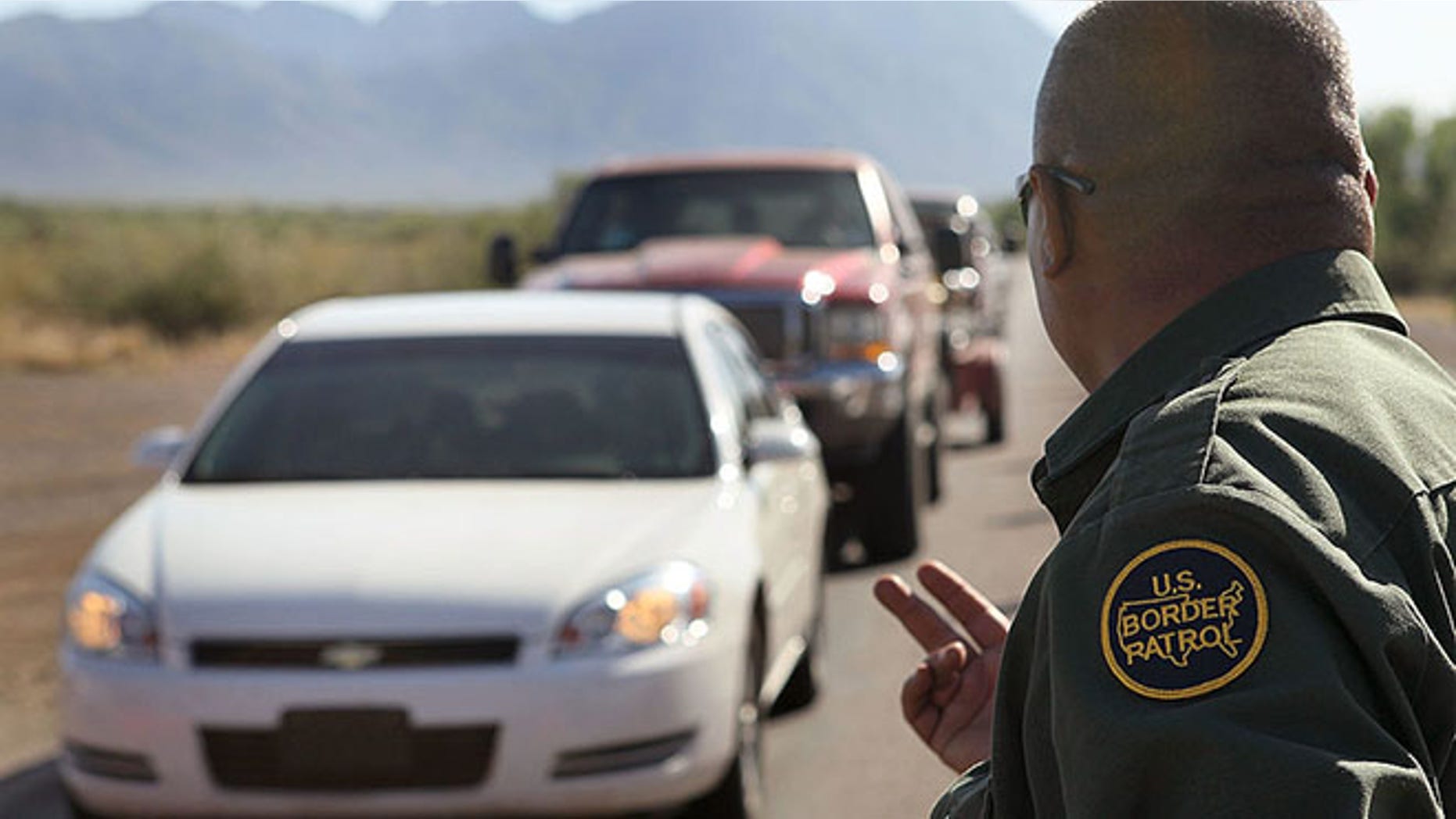 SASABE, AZ - JUNE 01: A Border Patrol agent checks vehicles for illegal immigrants and contraband at a roadside checkpoint June 1, 2010 near Sasabe, Arizona. During the 2009 fiscal year 540,865 undocumented immigrants were apprehended entering the United States illegally along the Mexican border, 241,000 of those were captured in the 262 mile stretch of the border known as the Tucson Sector. (Photo by Scott Olson/Getty Images)