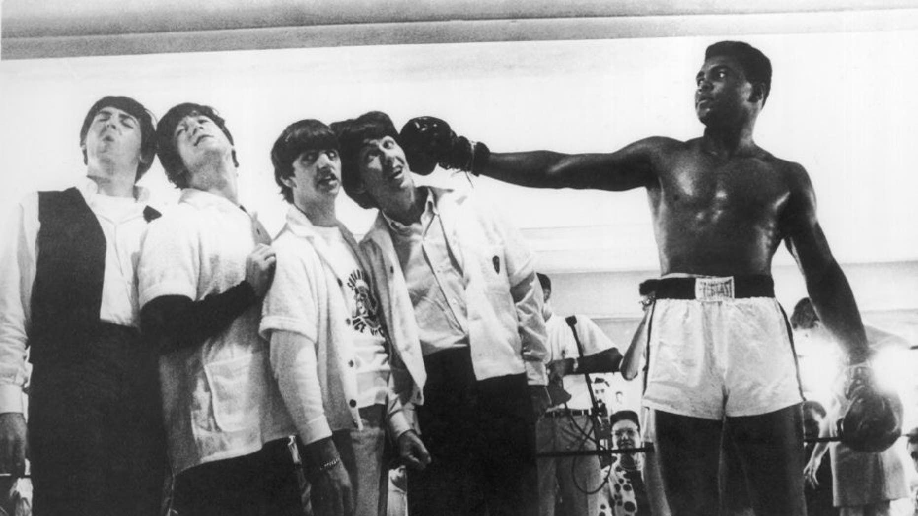 UNITED STATES - APRIL 22: During a visit to the training room of the boxer in Miami, the BEATLES were acting as they were knocked out by the American boxer Muhammad ALI, became recently boxe World Champion. (Photo by Keystone-France/Gamma-Keystone via Getty Images)