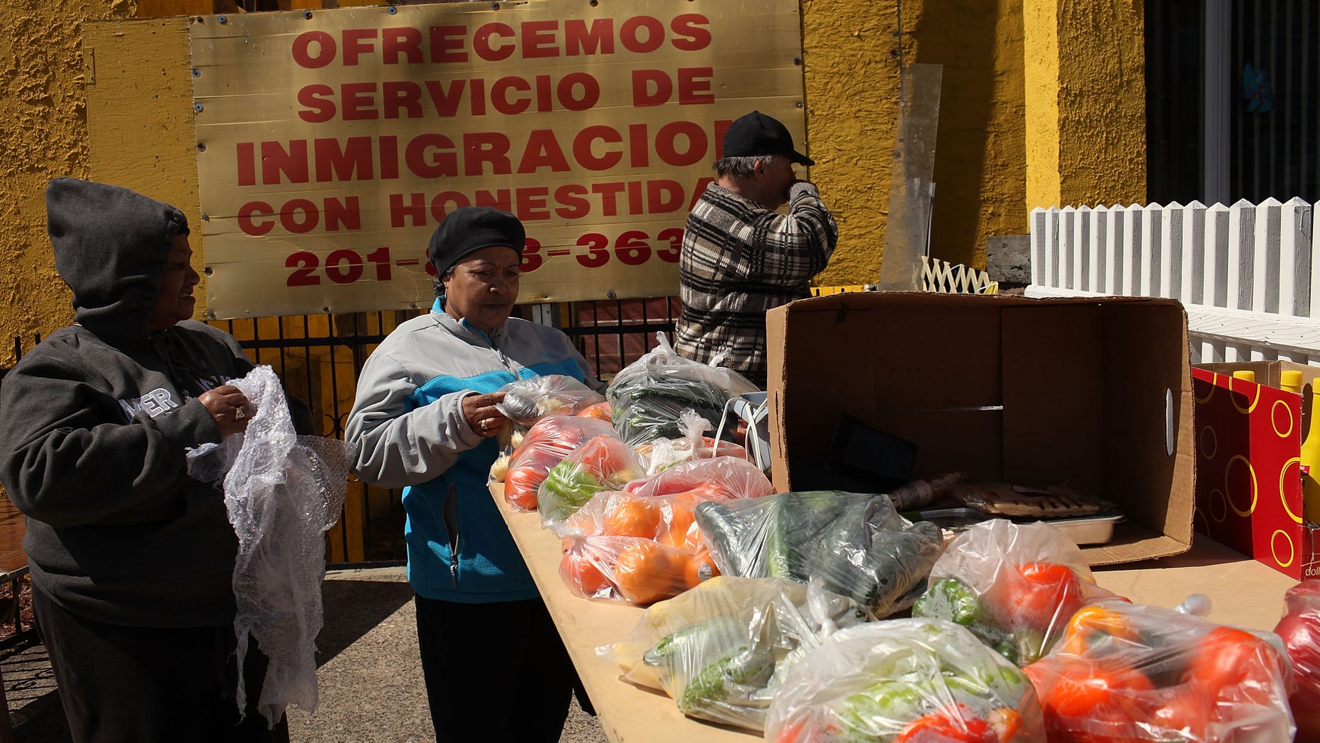 Hispanic women shop at a farmers market outside of a Latino church in Union City, New Jersey.