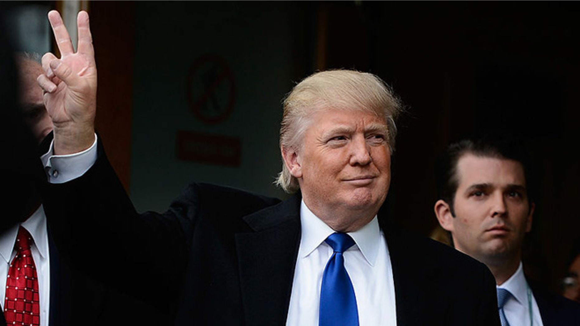 EDINBURGH, SCOTLAND - APRIL 25: Donald Trump gives the victory salute to members of public following his address to the Scottish Parliament on April 25, 20012 in Edinburgh, United Kingdom. Trump spoke of his concerns over a proposed wind farm, mooted to built near his new GBP 1 billion golf resort, telling the Scottish Parliament that they will destroy tourism in the country. (Photo by Jeff J Mitchell/Getty Images)