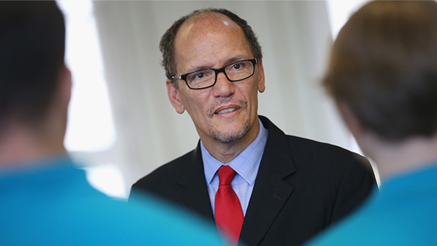 BERLIN, GERMANY - OCTOBER 28: U.S. Labor Secretary Thomas Perez chats with trainees at the Siemens training facility on October 28, 2014 in Berlin, Germany. Secretary Perez visited the center to learn more about the German trainee system, in which manufacturers offer paid multi-year training programs to recent high school graduates. U.S. President Obama has expressed interest in adopting the system in the U.S., where thus far training is usually conducted at technical or community colleges, as a way enhance job growth, meet the job requirements of U.S. industry and make the U.S. economy more competitive. (Photo by Sean Gallup/Getty Images)