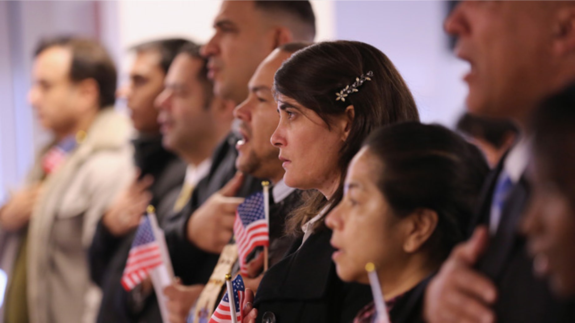 NEWARK, NJ - NOVEMBER 20: Immigrants take oath of citizenship to the United States on November 20, 2014 in Newark, New Jersey. Sixty immigrants from 25 countries became American citizens during the naturalization ceremony at the U.S. Immigration and Citizenship Services (USCIS) office at Newark's Federal Building. (Photo by John Moore/Getty Images)