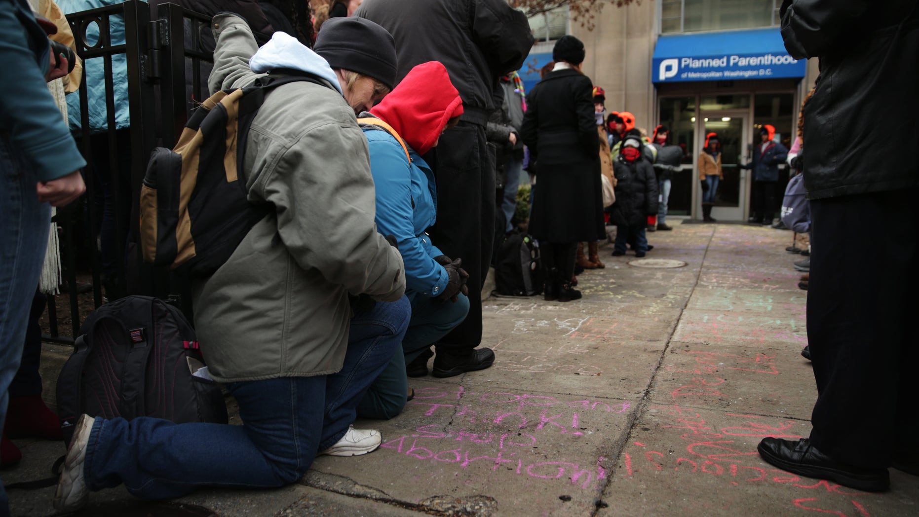 WASHINGTON, DC - JANUARY 21: Anti-abortion activists say prayers during a prayer vigil outside Planned Parenthood January 21, 2014 in Washington, DC. Activists from all around the country gathered in Washington for the annual March for Life tomorrow to protest the Roe v. Wade Supreme Court decision in 1973 that helped to legalize abortion in the United States. (Photo by Alex Wong/Getty Images)