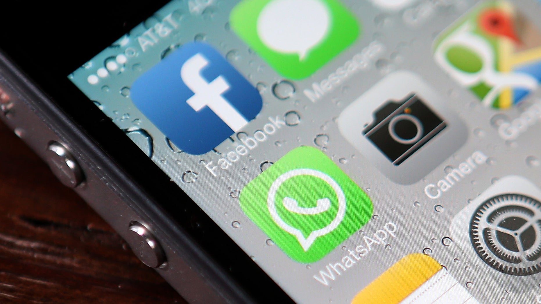 SAN FRANCISCO, CA - FEBRUARY 19: The Facebook and WhatsApp app icons are displayed on an iPhone on February 19, 2014 in San Francisco City. Facebook Inc. announced that it will purchase smartphone-messaging app company WhatsApp Inc. for $19 billion in cash and stock. (Photo illustration by Justin Sullivan/Getty Images)