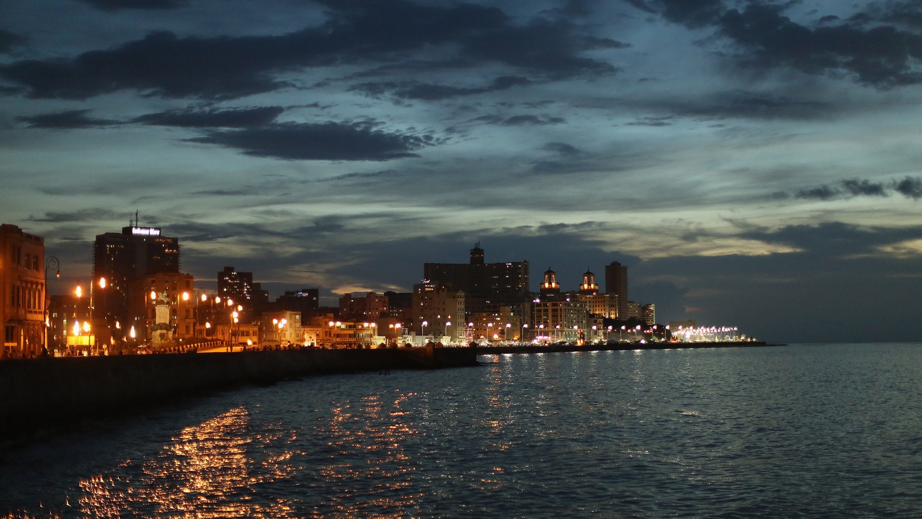 Streetlights along the Malecon seawall boulevard as the sun sets August 14, 2015 in Havana, Cuba.