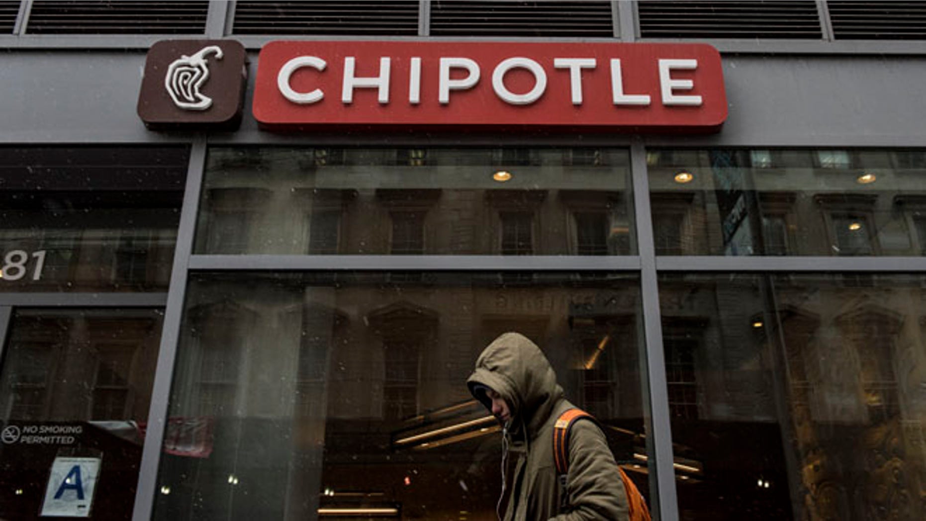 NEW YORK, NEW YORK -- FEBRUARY 8: A man walks past an empty Chipotle restaurant on Broadway in Lower Manhattan on February 8, 2016 in New York City. The Mexican food chain is closing stores for lunch nationwide for a meeting on food safety following a number of E. coli outbreaks. (Photo by Andrew Renneisen/Getty Images)