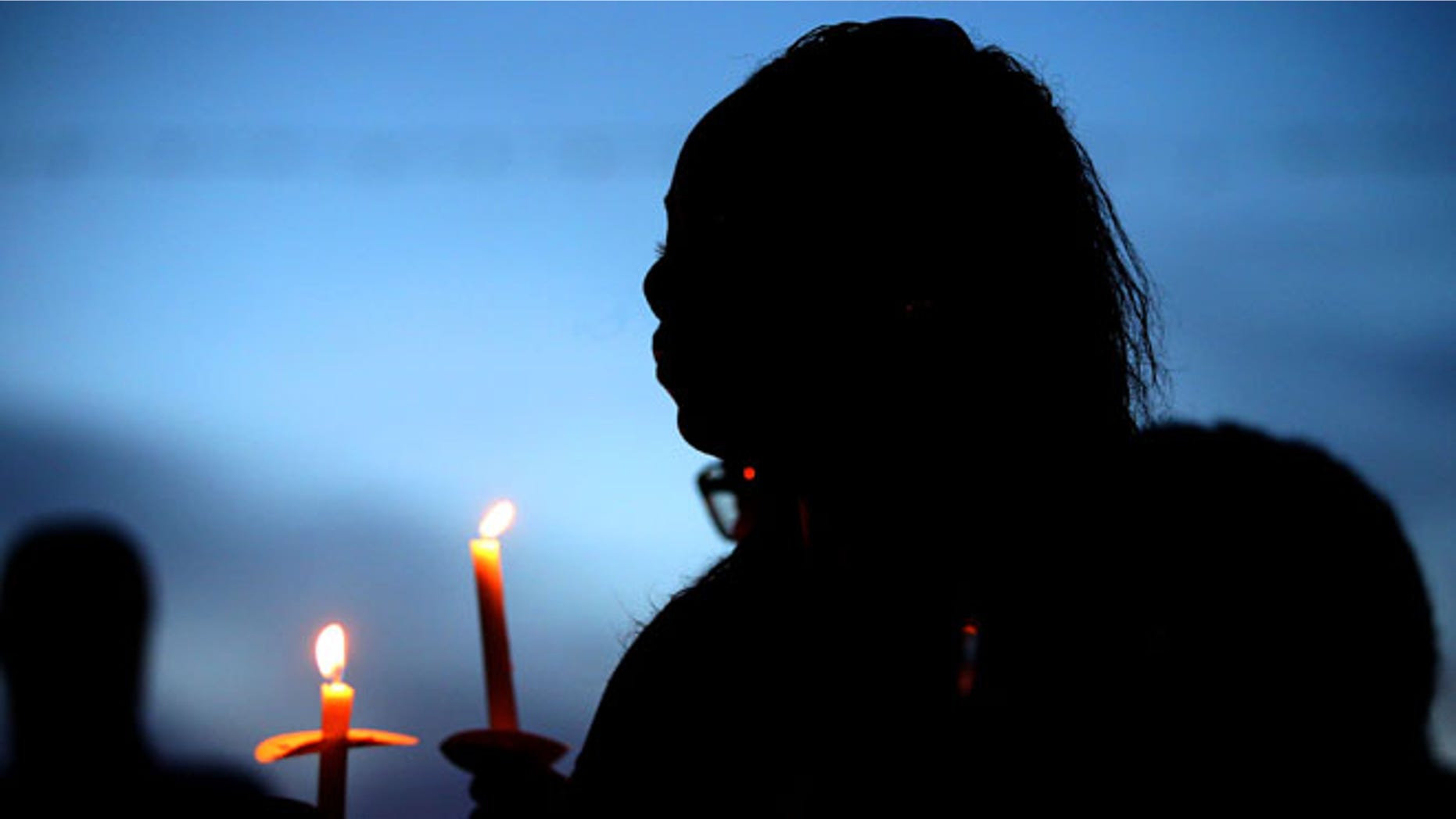 BATON ROUGE, LA - JULY 18: Mourners attend a candlelight vigil honoring Officer Matthew Gerald on July 18, 2016 in Baton Rouge, Louisiana. Officer Gerald, along with two other police officers, was shot and killed after gunman Gavin Long ambushed them on Sunday morning in front of the B-Quik gas station in Baton Rouge.(Photo by Sean Gardner/Getty Images)