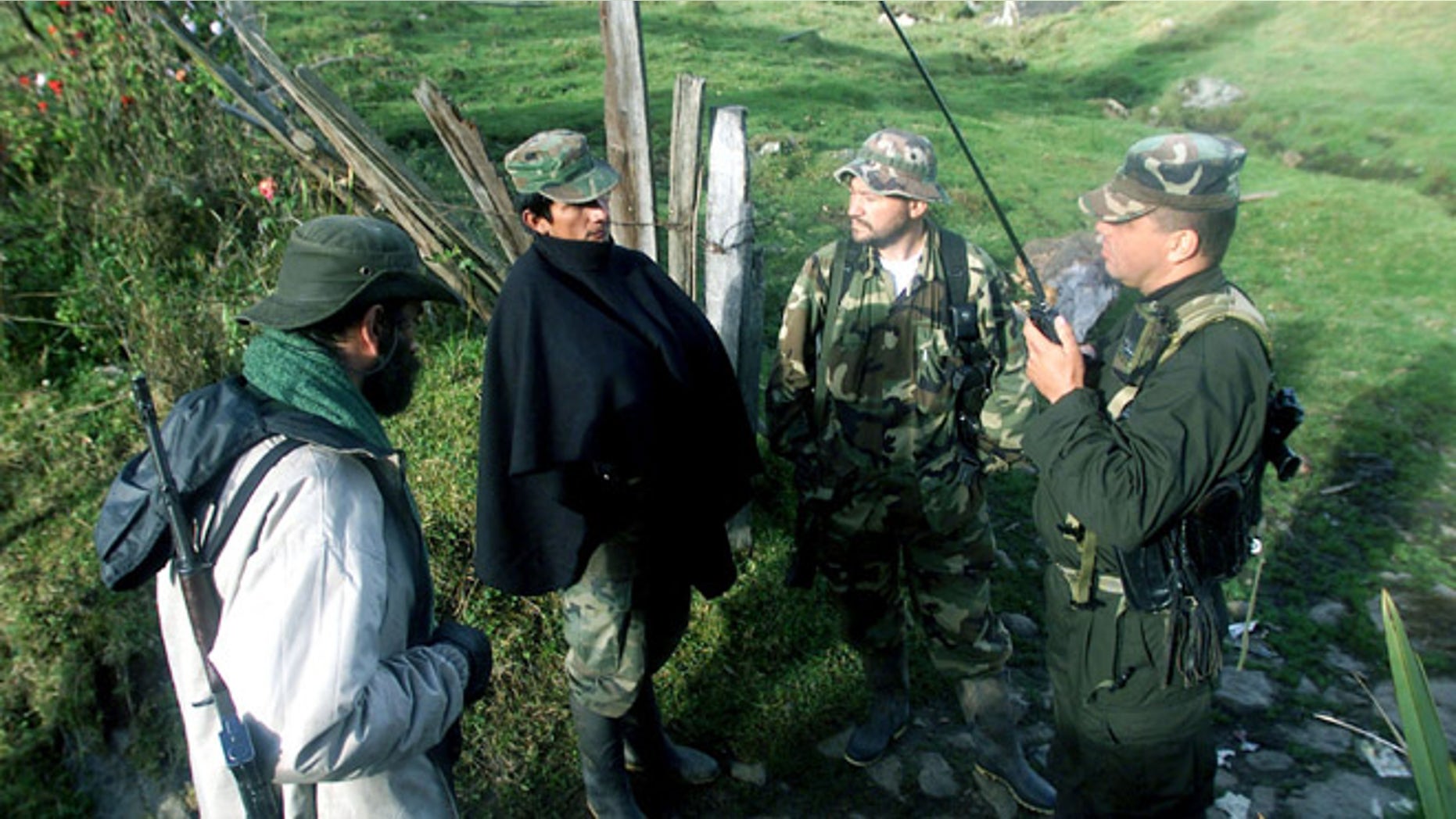 403499 01: (COLOMBIA OUT) Members of the Revolutionary Armed Forces of Colombia (FARC) listen to news from other FARC locations operating in the region April 7, 2002 in Cundinamarca, Colombia. The FARC guerrillas, once in San Vicente del Caguan, are now regrouping in the mountains of southern Bogota to allegedly start a new war strategy against the capital. (Photo by Carlos Villalon/Getty Images)