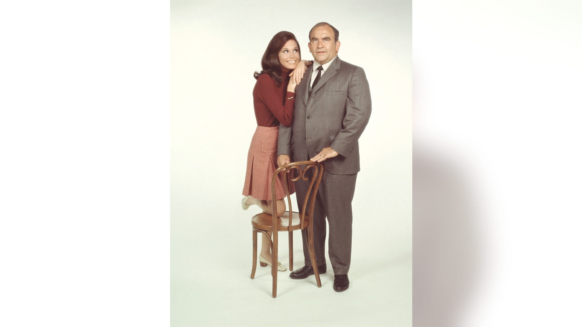 American actors Mary Tyler Moore, as Mary Richards, and Ed Asner, as Lou Grant, pose for a publicity photo for the CBS comedy, "The Mary Tyler Moore Show," in 1971.