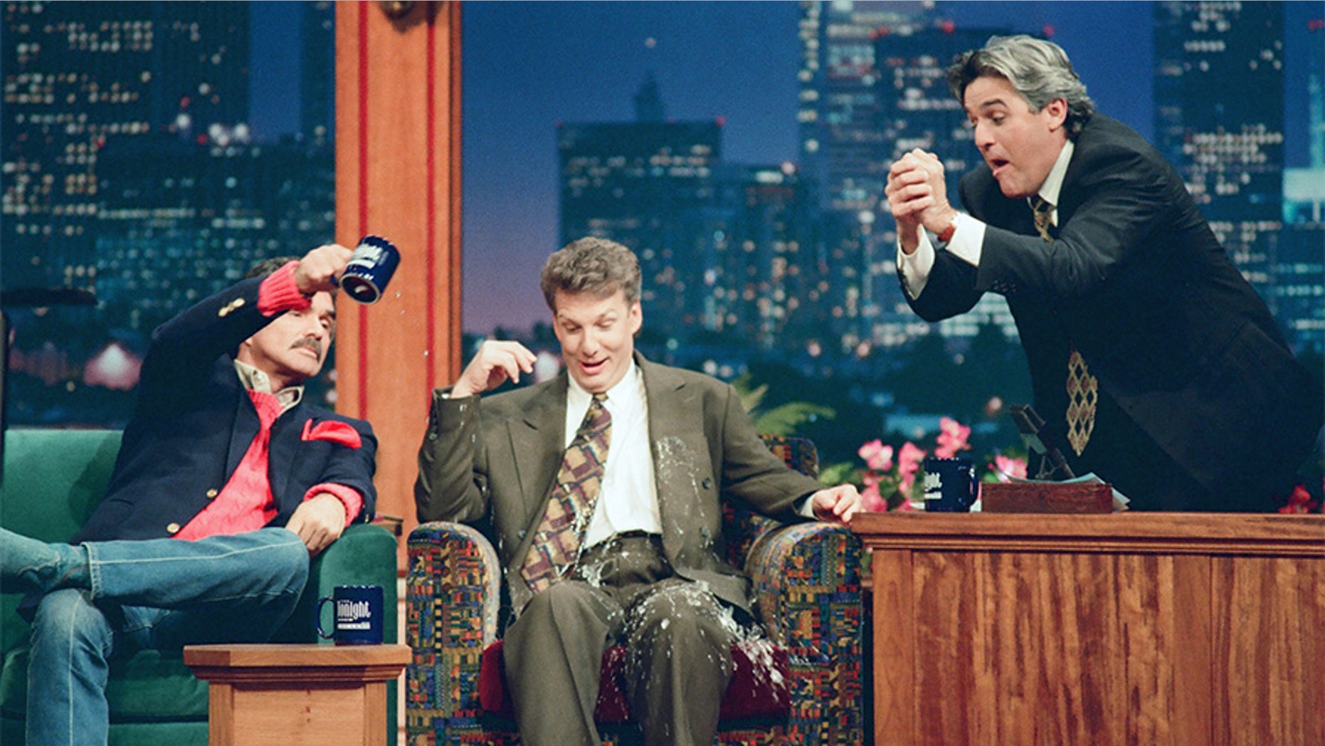 Pictured: (l-r) Actor Burt Reynolds, Television Personality Marc Summers during an interview with host Jay Leno on October 17, 1994.