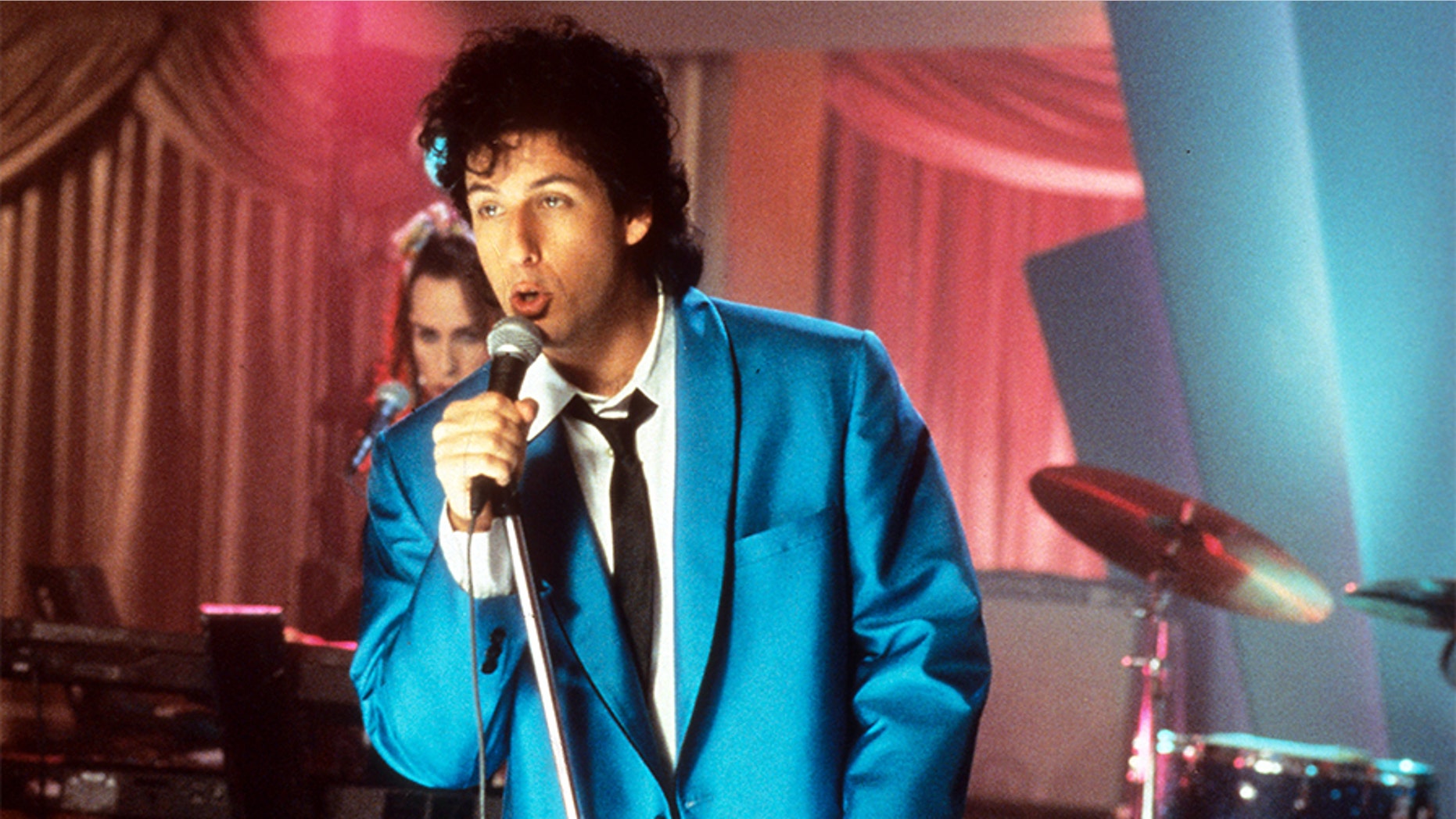 Adam Sandler sings in a scene from "The Wedding Singer," 1998.