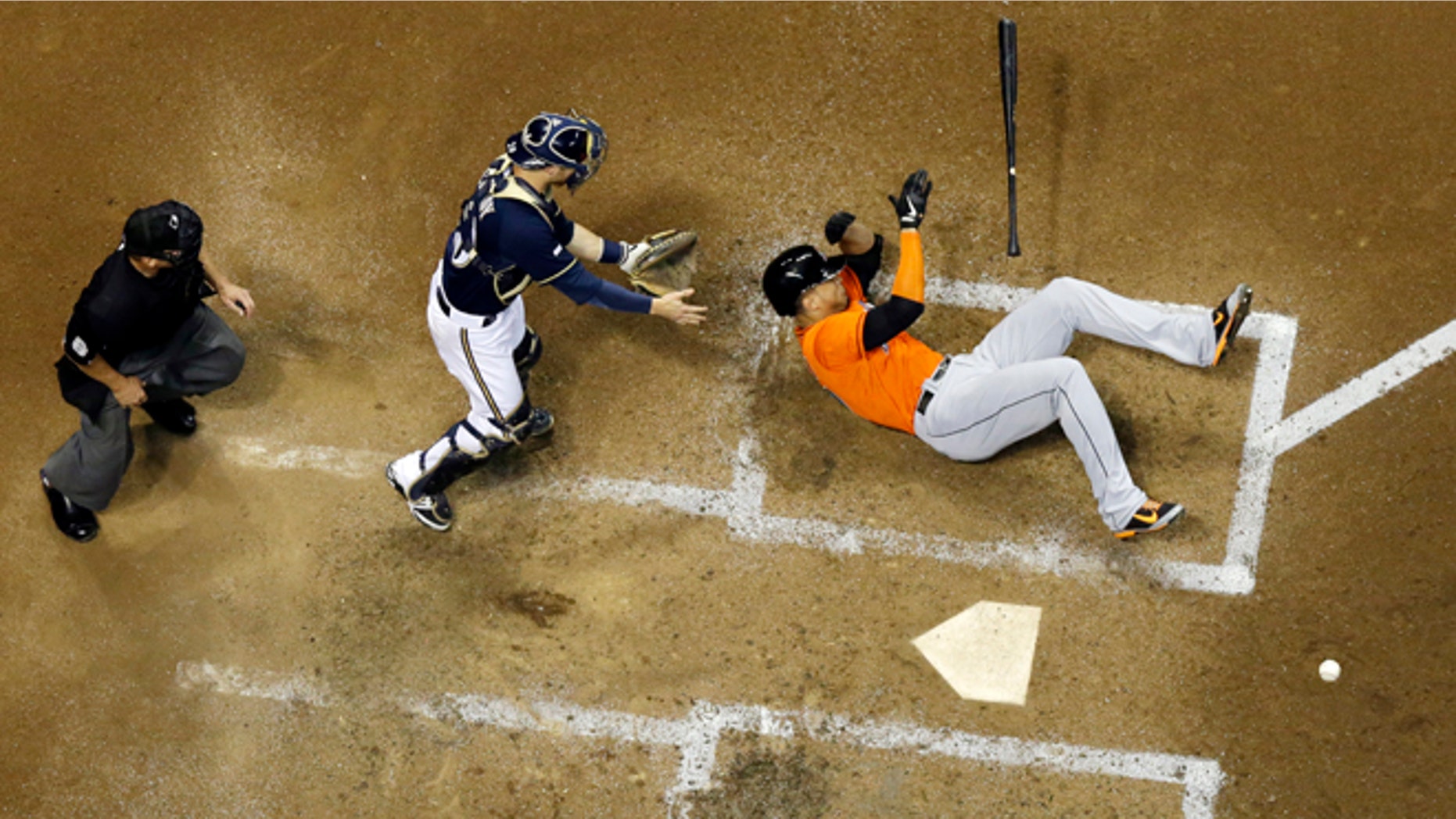 Miami Marlins' Giancarlo Stanton falls down after being hit in the face with a pitch during the fifth inning of a baseball game against the Milwaukee Brewers Thursday, Sept. 11, 2014, in Milwaukee. Stanton was taken off the field on a stretcher. (AP Photo/Morry Gash)