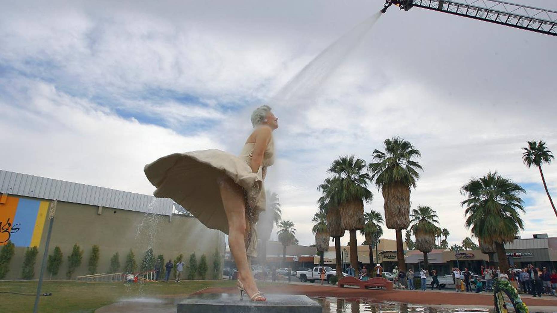 FILE - This Jan. 23, 2013 file photo shows the "Forever Marilyn" sculpture getting a shower from the Palm Springs Fire Department in Palm Springs, Calif. Palm Springs is singing “Goodbye, Norma Jean.” The city is throwing a send-off party Thursday March 27, 2014, for this massive statue of Marilyn Monroe that has become beloved by both tourists and locals in the two years it was on loan from The Sculpture Foundation.(AP Photo/The Desert Sun, Jay Calderon,File) RIVERSIDE PRESS-ENTERPRISE OUT; NO SALES; NO FOREIGN