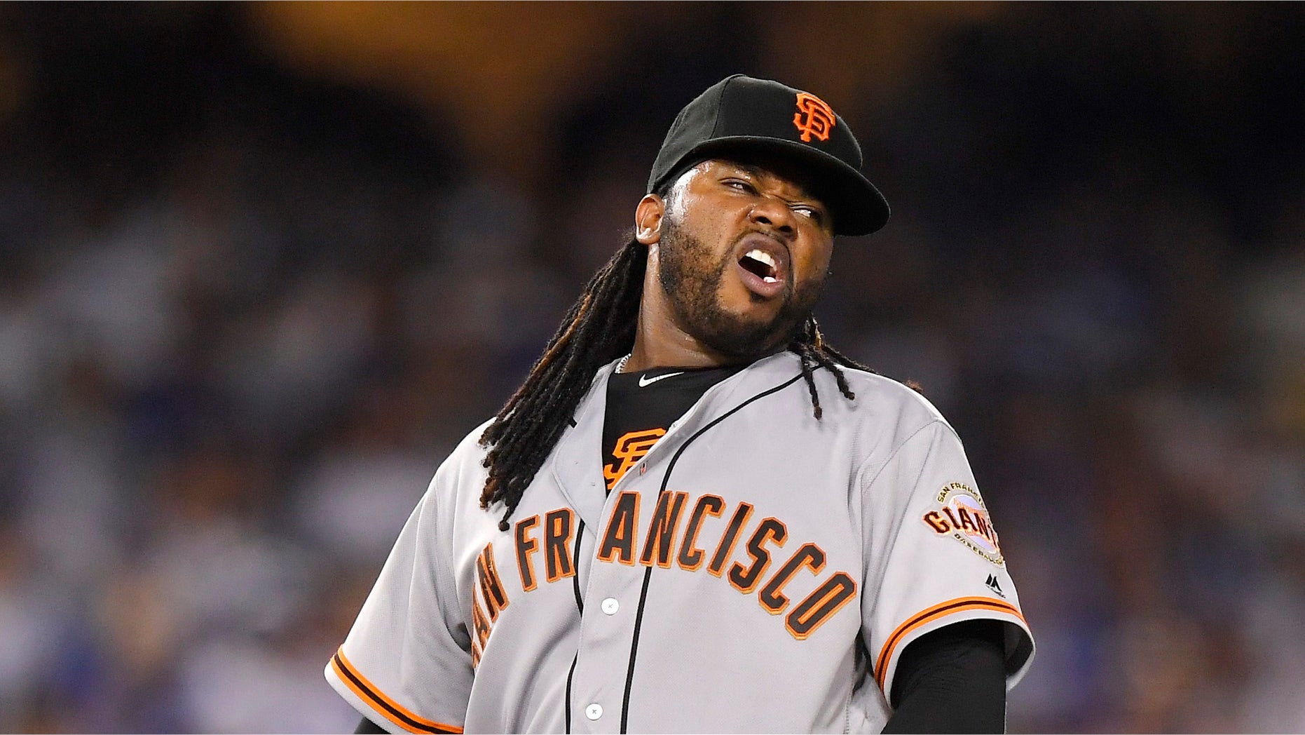 San Francisco Giants starting pitcher Johnny Cueto winces after injuring himself during the sixth inning of a baseball game against the Los Angeles Dodgers, Tuesday, Sept. 20, 2016, in Los Angeles. Cueto was taken out of the game soon after. (AP Photo/Mark J. Terrill)