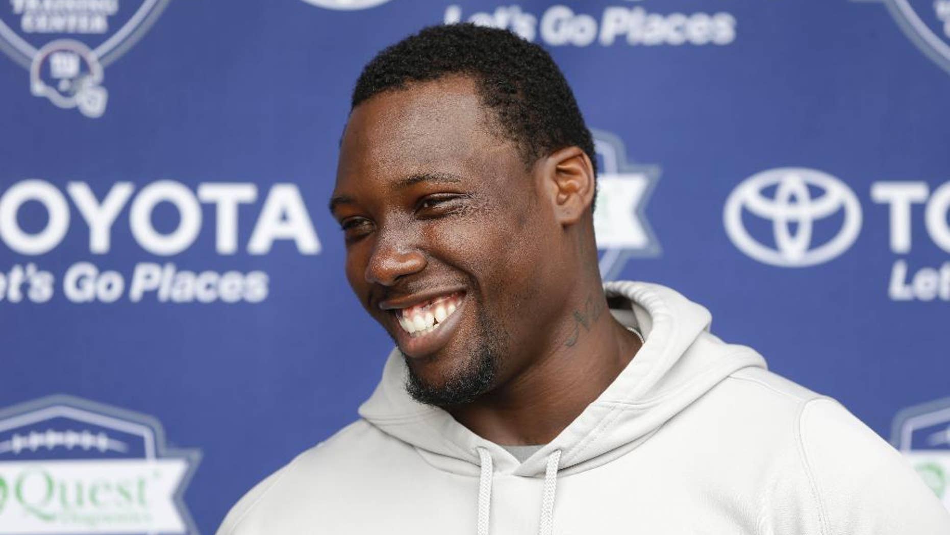 FILE - In this July 24, 2014, file photo, New York Giants' Jason Pierre-Paul talks to reporters during an NFL football camp in East Rutherford, N.J. Pierre-Paul has rapid-fire answers for just about anything he is asked, from the state of the New York Giants' defensive line to his own health to some missing teammates. (AP Photo/Seth Wenig, File)