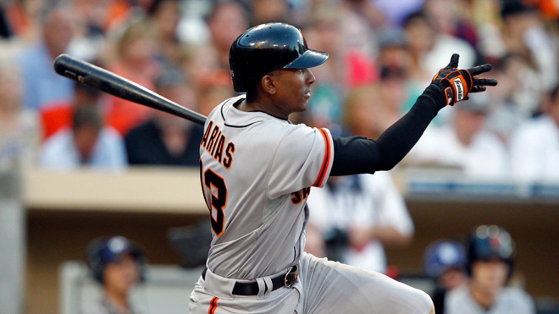 San Francisco Giants' Joaquin Arias follows through on an RBI single against the San Diego Padres during the fifth inning of a baseball game in San Diego, Saturday, Aug. 18, 2012. (AP Photo/Alex Gallardo)