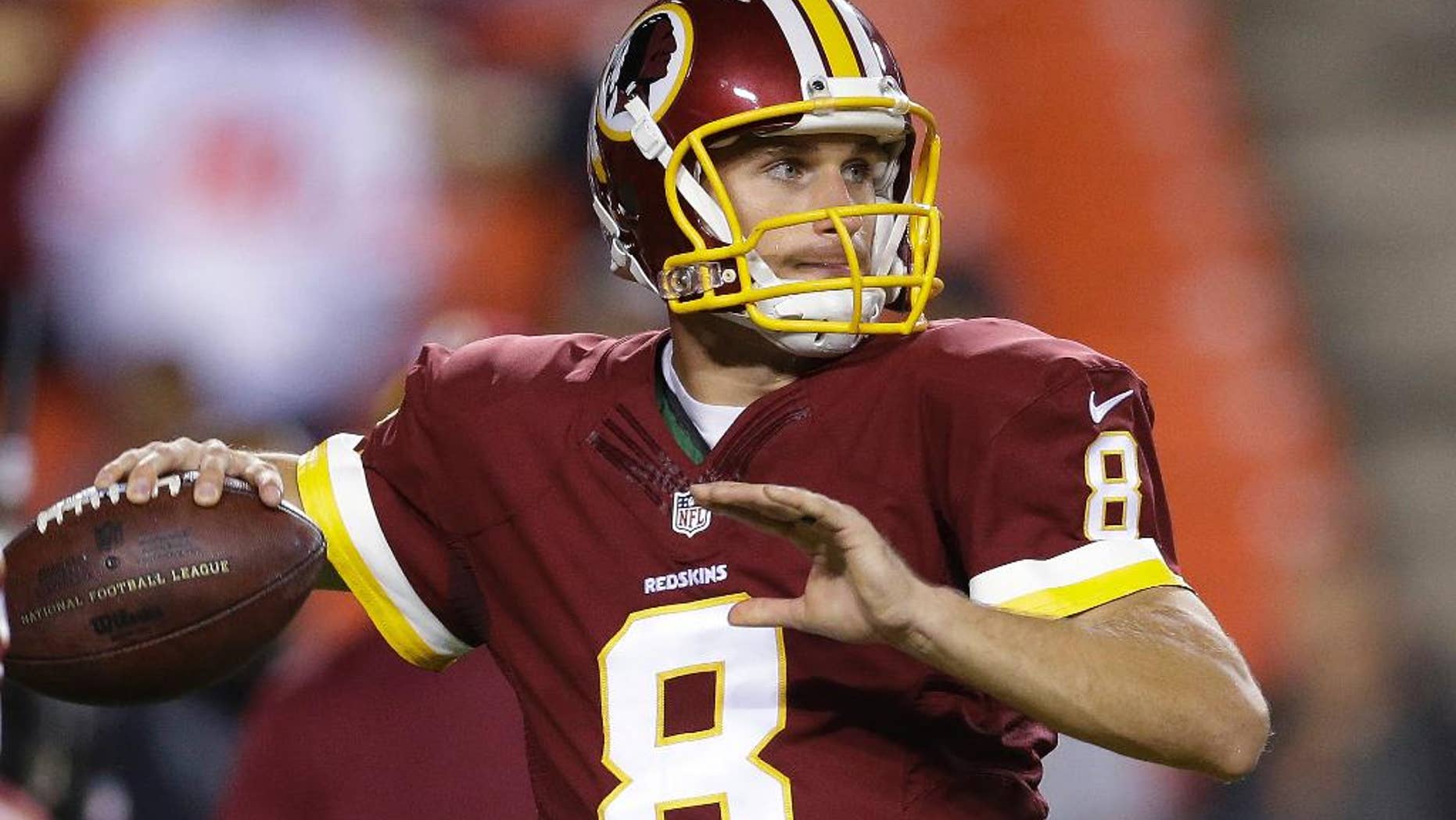Washington Redskins quarterback Kirk Cousins warms up before an NFL football game against the New York Giants in Landover, Md., Thursday, Sept. 25, 2014. (AP Photo/Patrick Semansky)