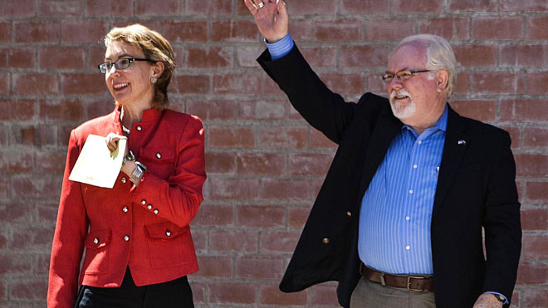 June 12, 2012: Former Rep. Gabrielle Giffords, left, and Ron Barber enter the polling place at St. Cyril's Catholic Church in Tucson, Ariz.