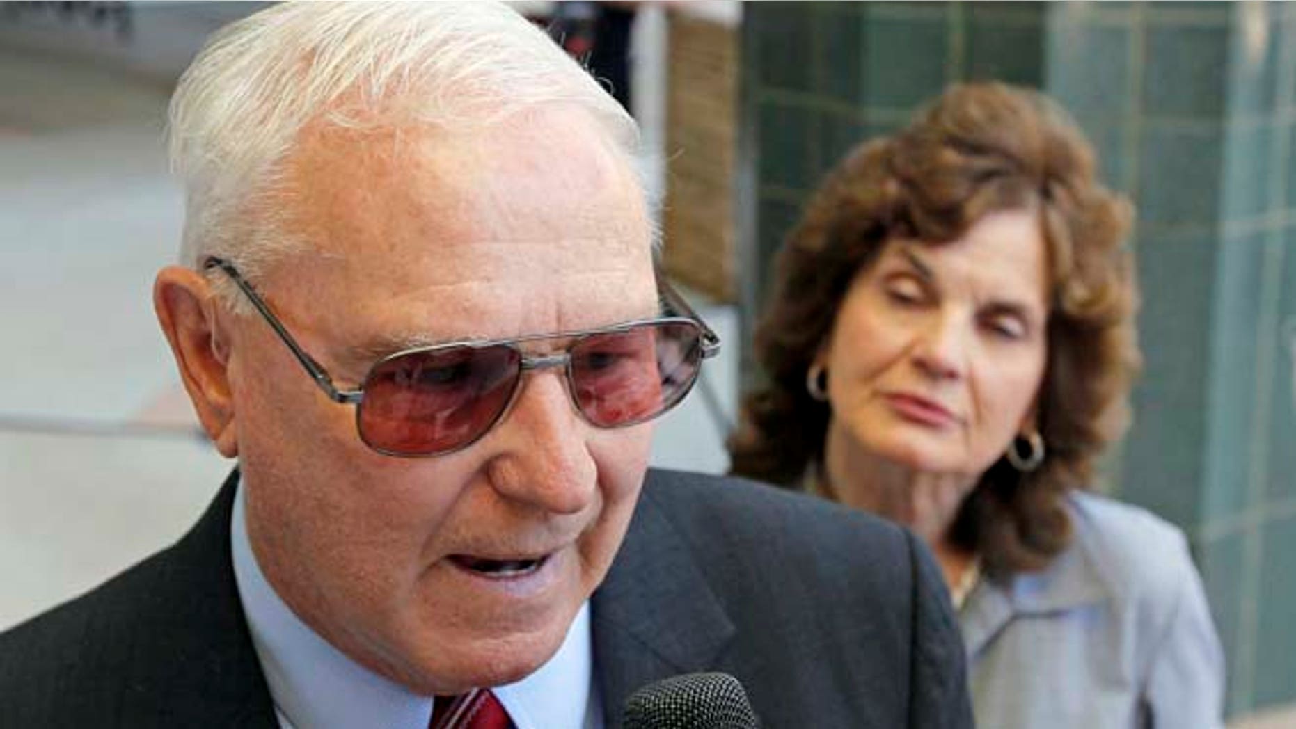 Aug. 7, 2012: Shooting victim Bill Badger, left, speaks to the media as his wife Sallie Badger looks on after Jared Lee Loughner, who killed six and wounded 13 people in a 2011 shooting spree, entered a plea agreement sending him to prison for the rest of his life, in Tucson, Ariz. (AP)