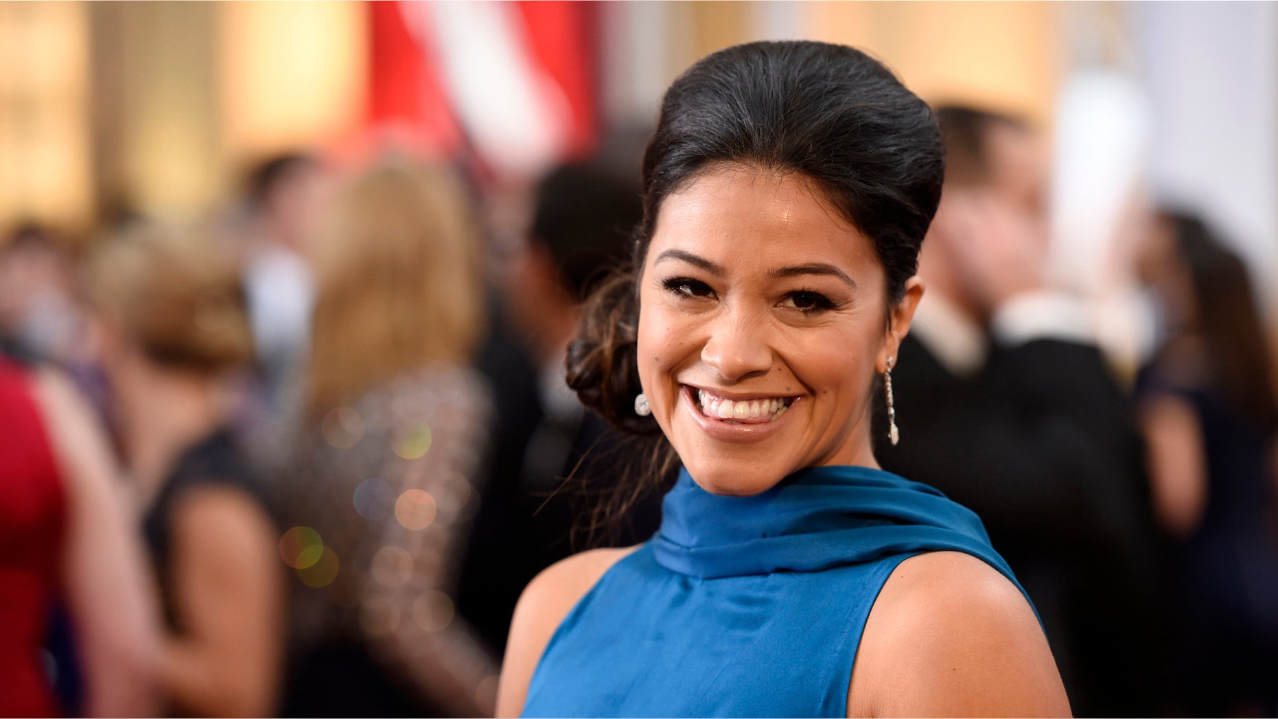 Gina Rodriguez arrives at the Oscars on Sunday, Feb. 22, 2015, at the Dolby Theatre in Los Angeles. (Photo by Chris Pizzello/Invision/AP)