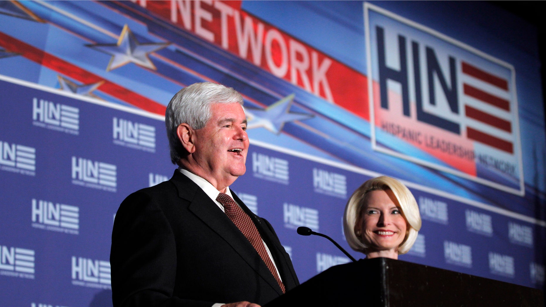 Republican presidential candidate, former House Speaker Newt Gingrich, accompanied by his wife Callista, speaks during Hispanic Leadership Network conference at the Doral Golf Resort and Spa, Friday, Jan. 27, 2012, in Miami, Fla. (AP Photo/Matt Rourke)