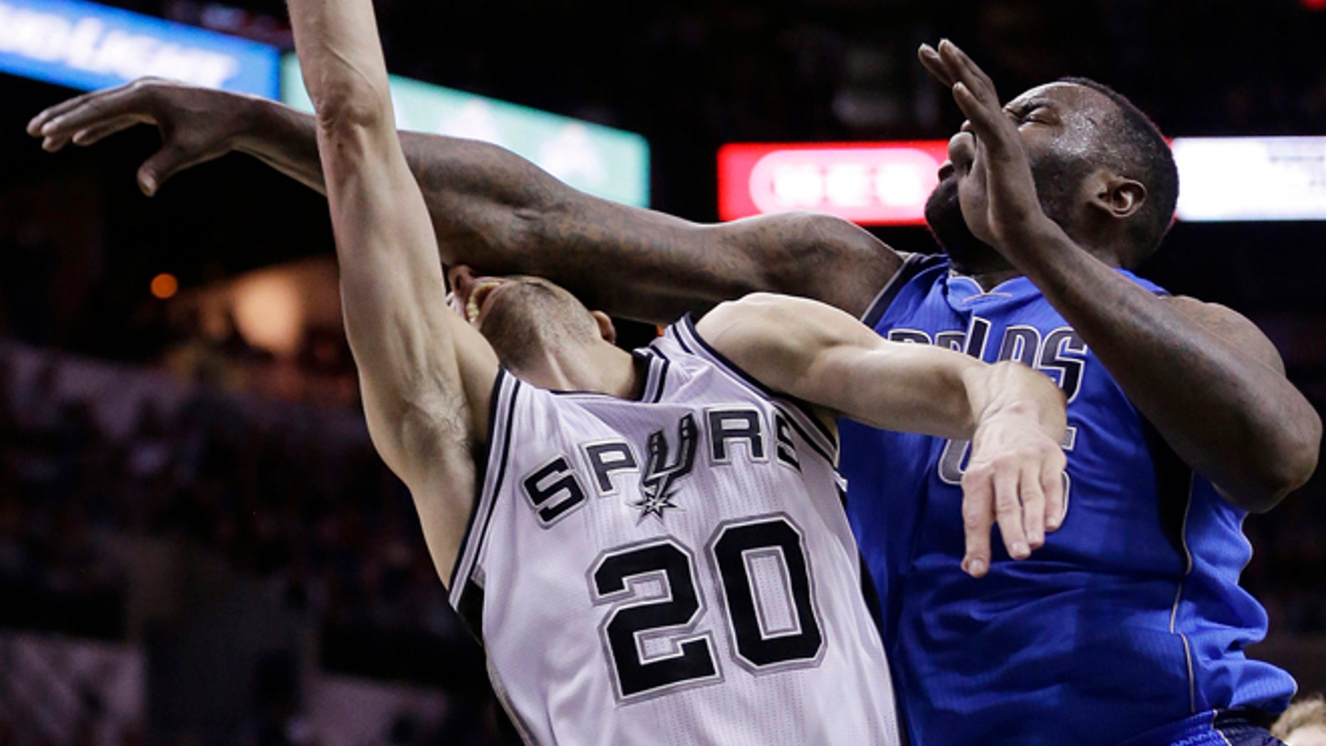 San Antonio Spurs' Manu Ginobili (20), of Argentina, is fouled hard by Dallas Mavericks' DeJuan Blair (45) during the first half of Game 7 of the opening-round NBA basketball playoff series, Sunday, May 4, 2014, in San Antonio. Blair was awarded a flagrant foul on the play.(AP Photo/Eric Gay)