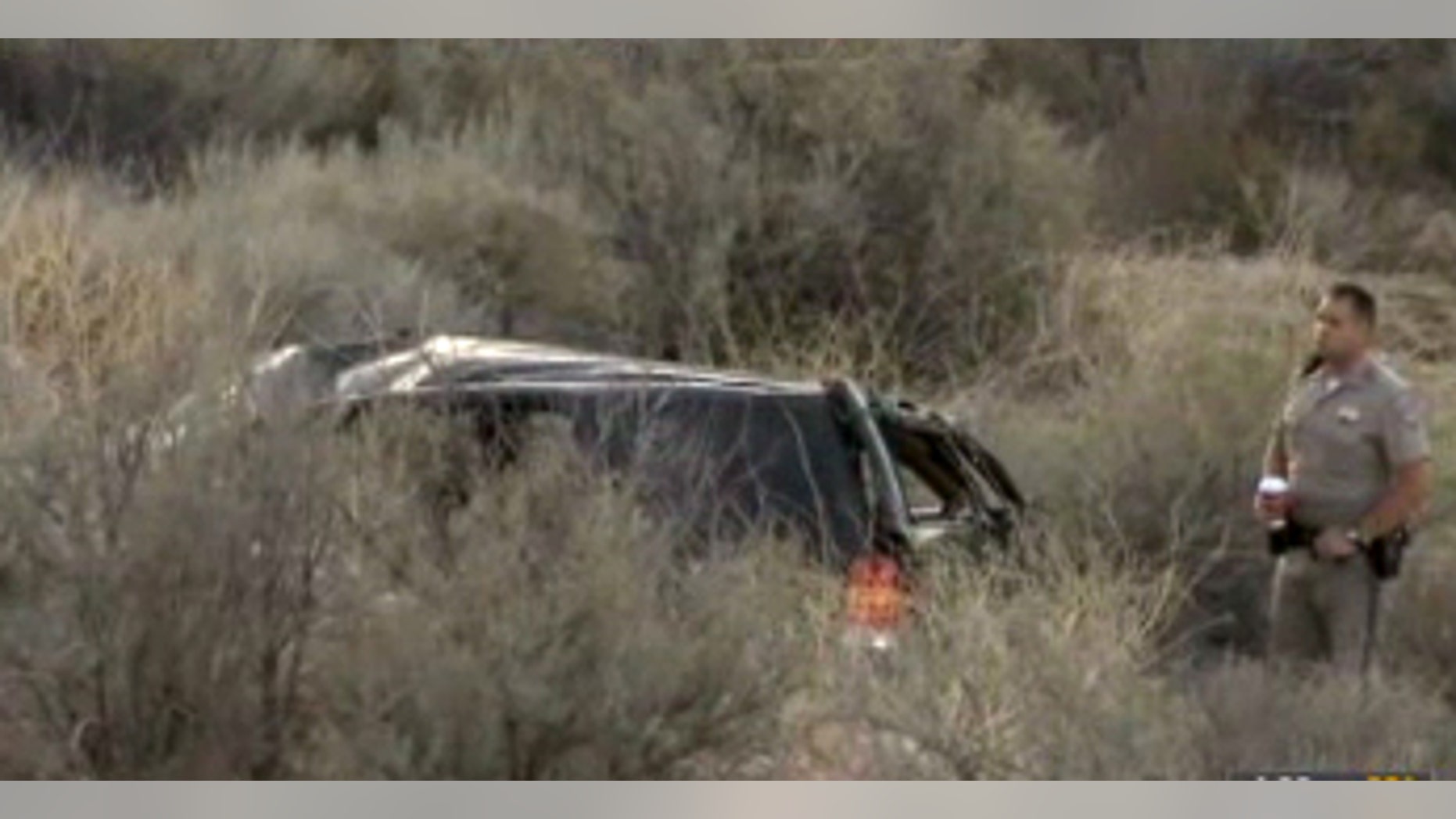 This video frame provided by KABC TV Los Angeles shows a California Highway Patrol officer during an investigation of a crash of an SUV in Action, Calif. on Sunday, March 24, 2013. A 9-year-old girl crawled out of the mangled SUV, climbed out of a canyon and walked about a mile in the middle of the night to find help after surviving the highway crash that killed her father in Southern California, authorities said. (AP Photo/KABC TV)