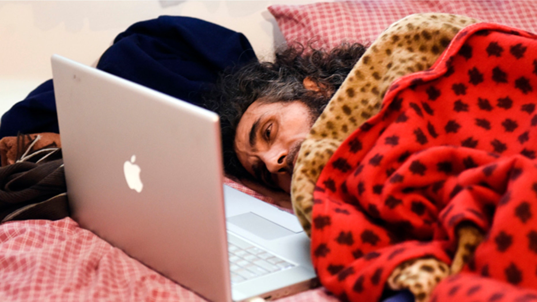 In this Friday, Sept. 9, 2016 photo, Syrian native Abu Wa'el Dhiab, a former Guantanamo detainee, rests in bed as he speaks to his family via a laptop, in his apartment in Montevideo, Uruguay. Activists and Uruguayan officials say the health of the former Guantanamo detainee resettled in the South American country is deteriorating as he continues a hunger strike at his home. Dhiab is demanding to leave Uruguay, which took him in with five other former Guantanamo prisoners in 2014. (AP Photo/Matilde Campodonico)