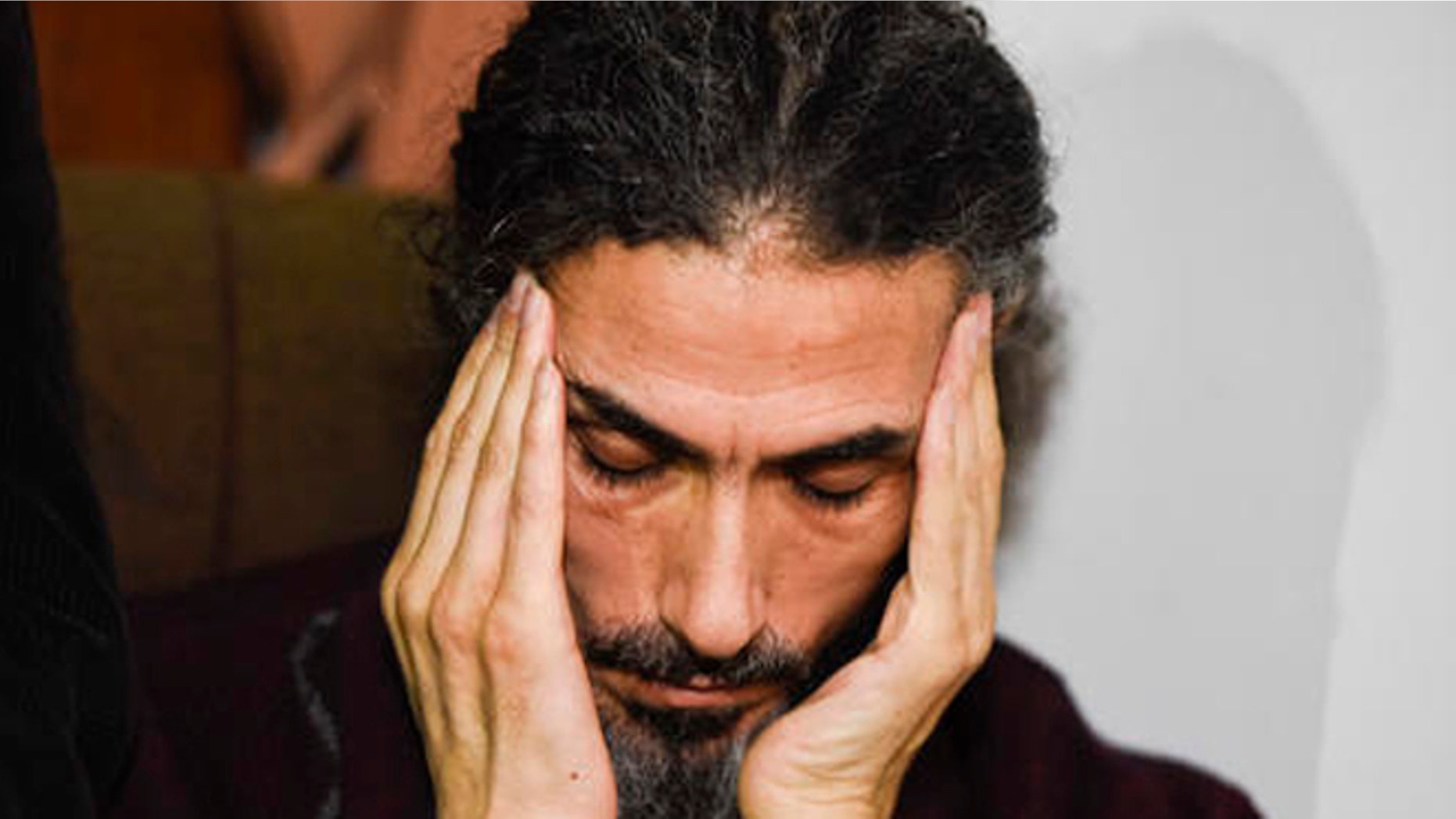Former Guantanamo detainee Syrian Abu Wa'el Dhiab listens to a question as he holds a press conference at his apartment in Montevideo, Uruguay, Friday, Sept. 30, 2016. Uruguay's government says it is searching for another country to take Dhiab who is threatening to die on a hunger strike if he's not allowed to reunite with his family elsewhere. (AP Photo/Matilde Campodonico)