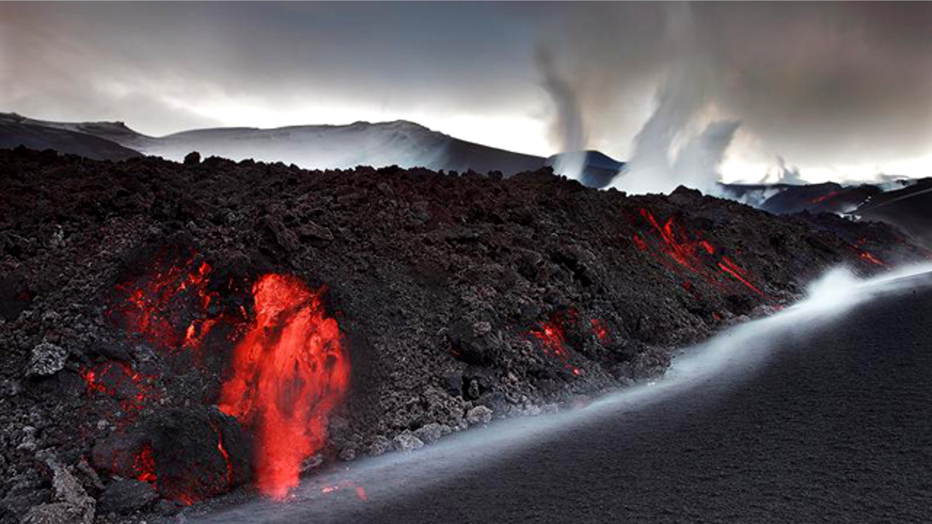 Smoke and steam from the volcano under the Eyjafjallajokull glacier in Iceland have forced hundreds of people to flee rising floodwaters and disrupted plane traffic across Europe.