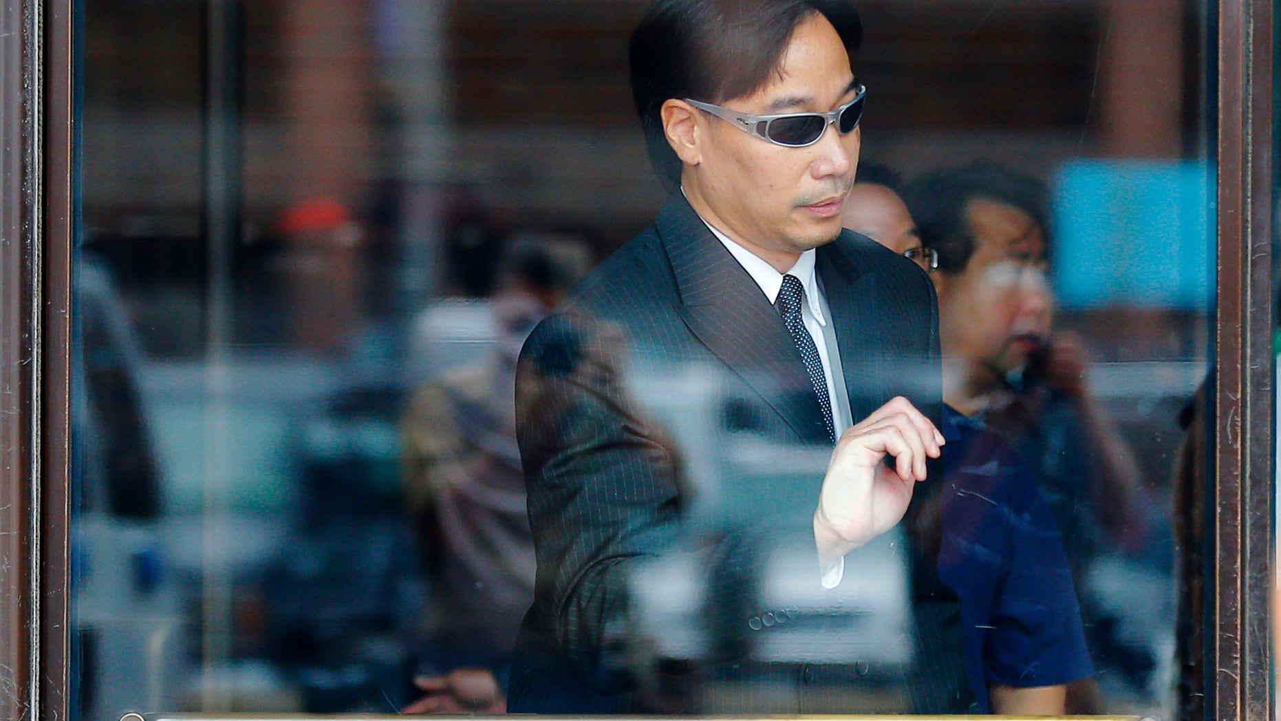 Glenn Adam Chin leaves the federal courthouse in Boston, Massachusetts September 11, 2014 following his arraignment on a mail fraud charge. REUTERS/Brian Snyder