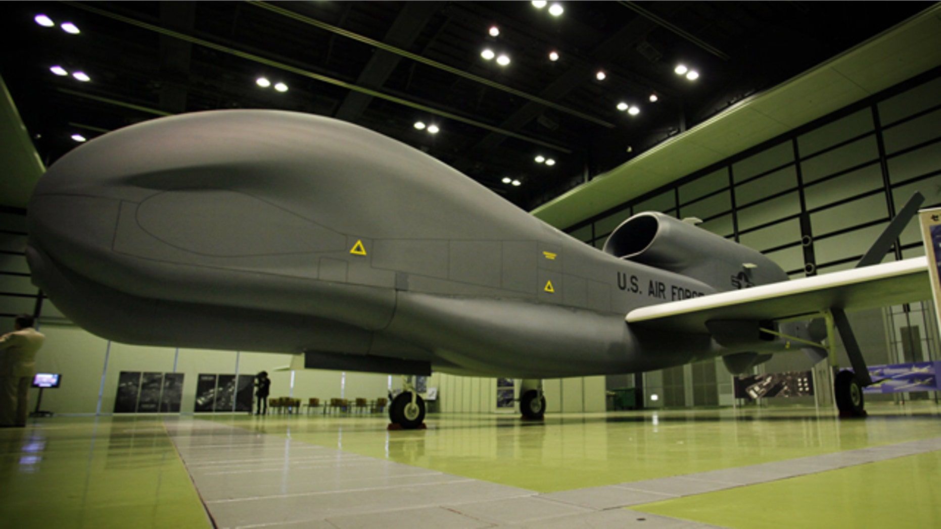 A mockup of Northrop Grumman's Unmanned Aerial Reconnaissance System RQ-4 Global Hawk is on display during a press briefing of the plane at a public exhibition hall in Tokyo, Wednesday, March 24, 2010. The Global Hawk can fly at altitudes of more than 60,000 feet for more than 32 hours and send near real-time reconnaissance imagery and signals intelligence data to forces in the air, on the ground and at sea.