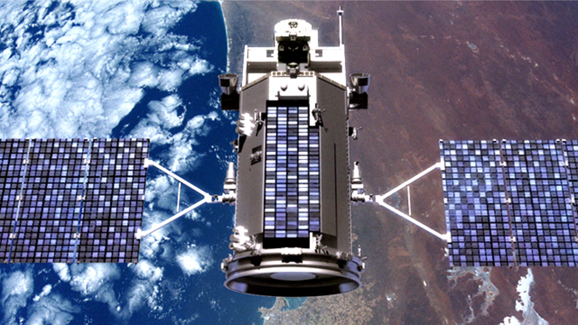 An illustration of the Glory satellite in orbit over the Earth.