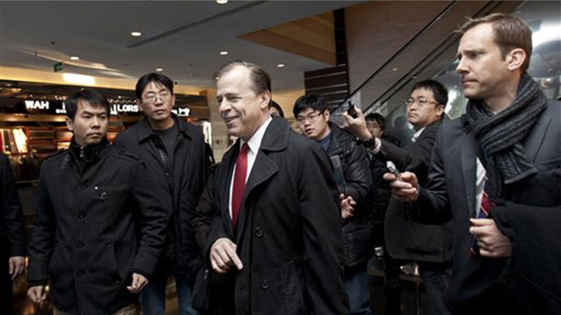 Feb. 23, 2012: U.S. envoy for North Korean Affairs Glyn Davies, center, is surrounded by journalists after giving a statement to media at a hotel in Beijing, China.