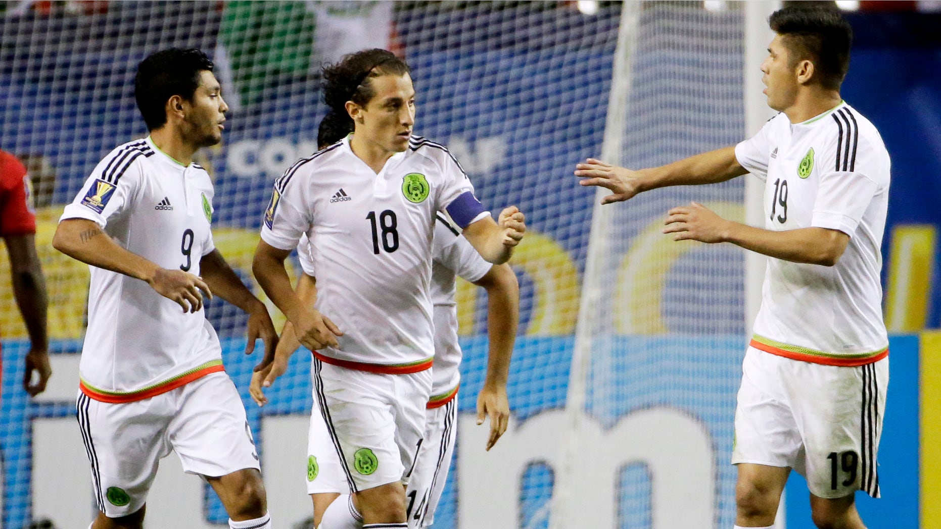 Mexicoâs Andres Guardado, center, is congratulated by teammates Jesus Corona, left, and Oribe Peralta after scoring on a penalty kick during the second half of a CONCACAF Gold Cup soccer semifinal against Panama on Wednesday, July 22, 2015, in Atlanta. (AP Photo/David Goldman)