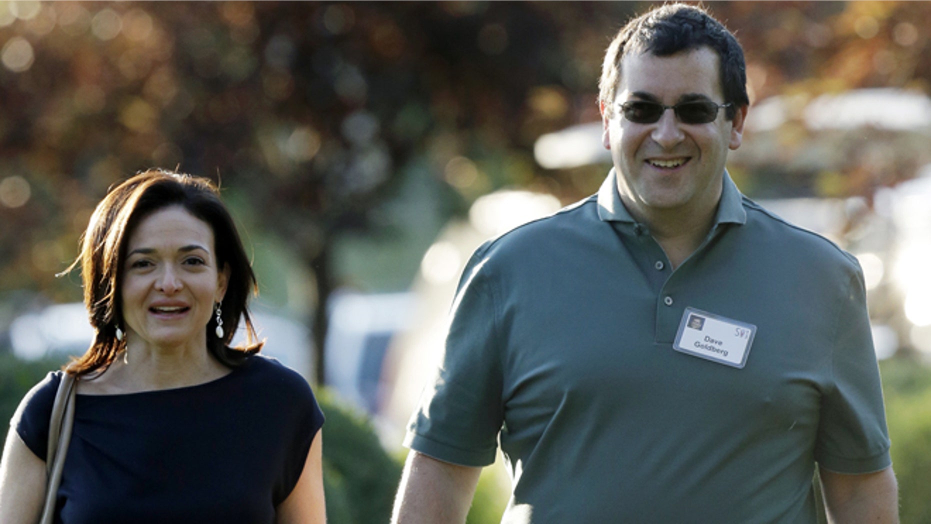 FILE - In this July 10, 2013 file photo, Sheryl Sandberg, COO of Facebook, left, and her husband David Goldberg, CEO of SurveyMonkey, walk to the morning session at the Allen & Company Sun Valley Conference in Sun Valley, Idaho. Goldberg was exercising at a gym in a Mexican resort when he collapsed before he died Friday, May 1, 2015, a person close to the family says. (AP Photo/Rick Bowmer, File)