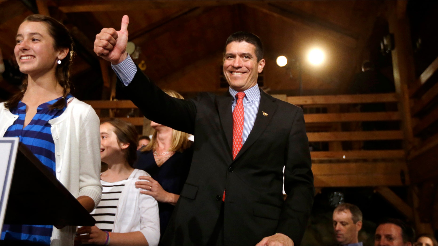 Republican candidate for the U.S. Senate Gabriel Gomez, center, gives a thumbs up as he takes to the stage next to his daughter Olivia, 13, left, before addressing an audience with a victory speech at a watch party, in Cohasset, Mass., Tuesday, April 30, 2013. Gomez won his primary bid for the Republican nomination to contest a U.S. Senate seat, defeating Republican hopefuls Michael Sullivan and Dan Winslow. (AP Photo/Steven Senne)