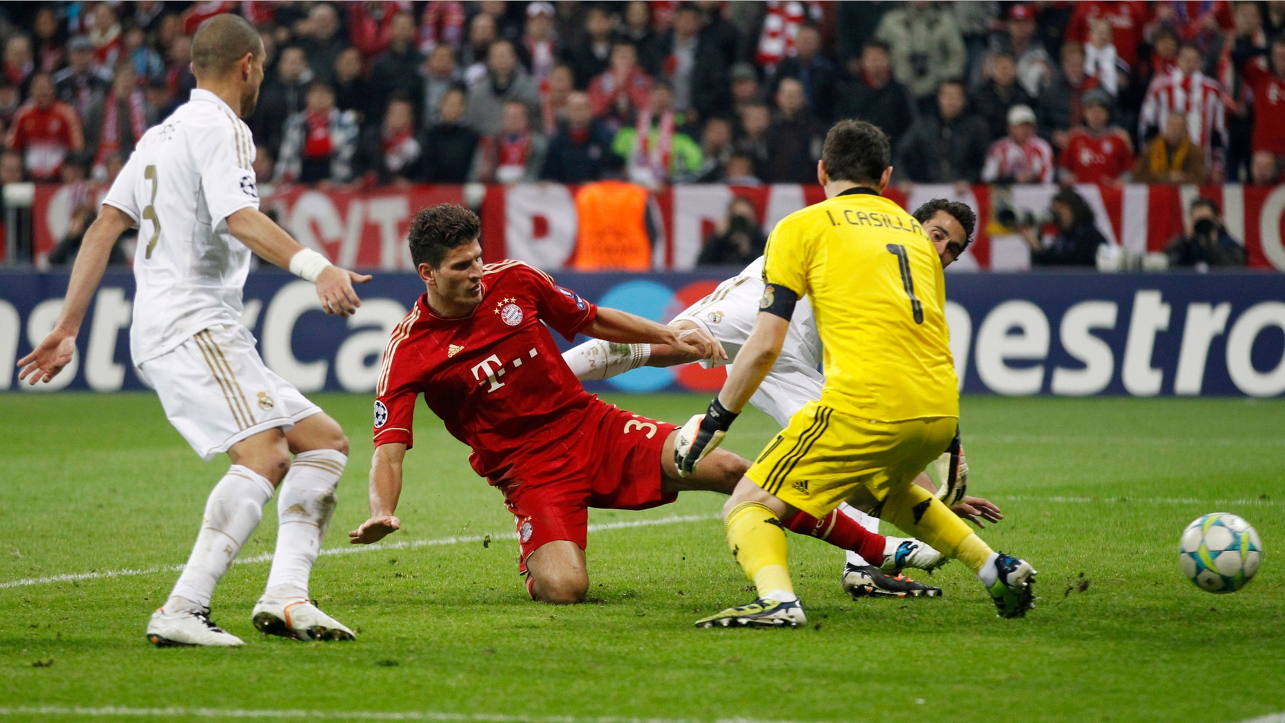 Bayern's Mario Gomez scores his side's 2nd goal past Madrid goalkeeper Iker Casillas, right, during the Champions League first leg semifinal soccer match between Bayern Munich and Real Madrid in Munich, southern Germany, Tuesday, April 17, 2012. (AP Photo/Matthias Schrader)