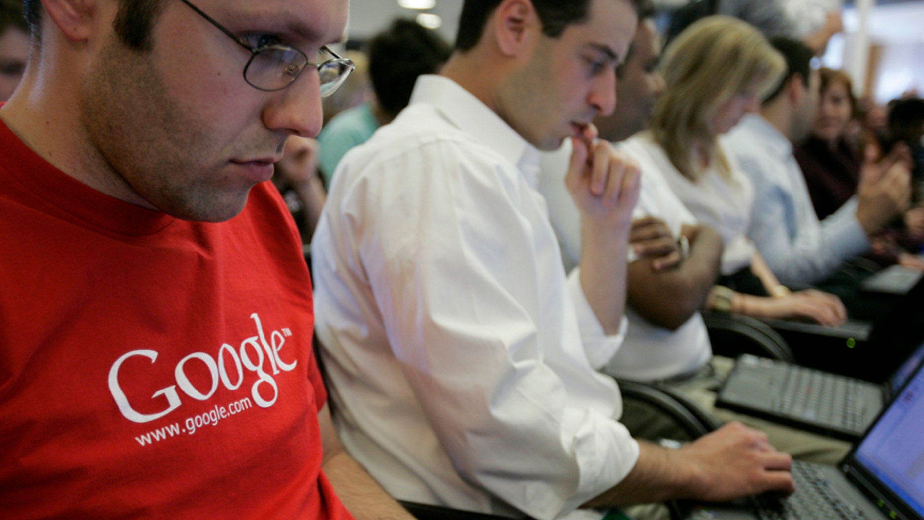 In this May 30, 2007 file photo, Google employees work on their laptops at Google headquarters in Mountain View, California.