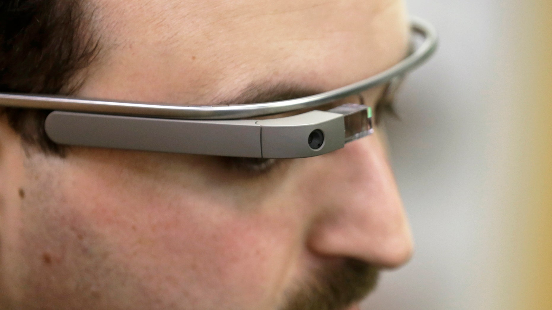 Developer Maximiliano Firtman wears the prototype device Google Glass before a news conference. (REUTERS/Ints Kalnins)