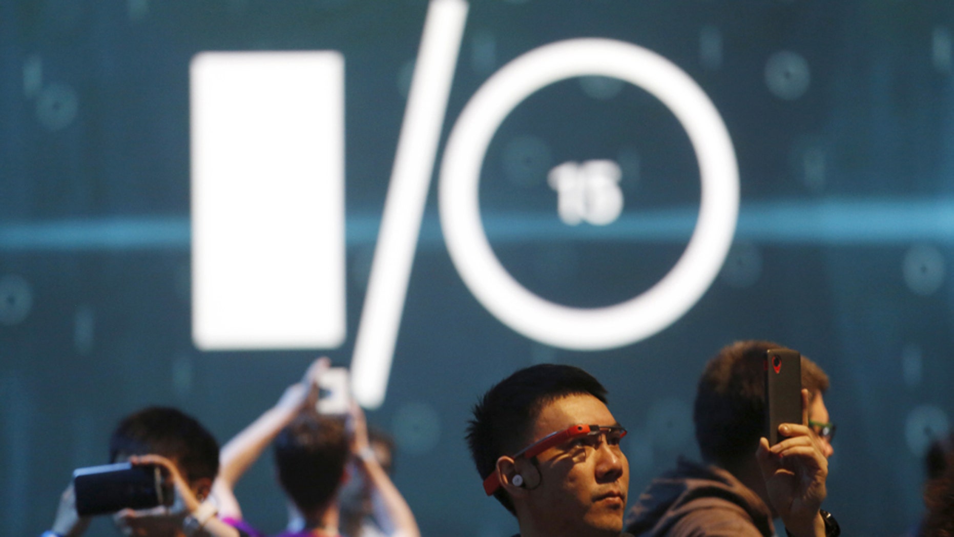 Attendees use mobile devices prior to the start of the Google I/O developers conference in San Francisco, California May 28, 2015.