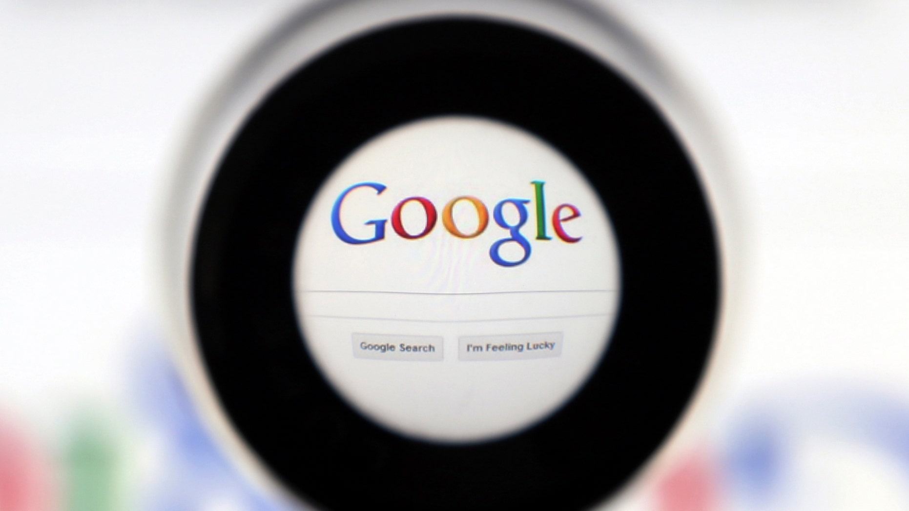 A Google search page is seen through a magnifying glass in this photo illustration taken in Brussels May 30, 2014. Google has taken the first steps to meet a European ruling that citizens can have objectionable links removed from Internet search results, a ruling that pleased privacy campaigners but raised fears that the right can be abused to hide negative information. REUTERS/Francois Lenoir (BELGIUM - Tags: SCIENCE TECHNOLOGY POLITICS) - RTR3RK8U