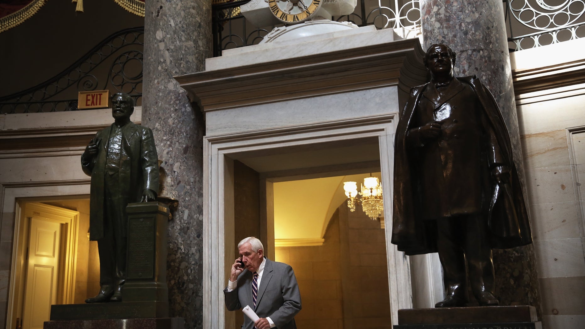 WASHINGTON, DC - OCTOBER 03: U.S. Rep. Frank Wolf (R-VA) talks on his cellular phone as he passes through the Statuary Hall at the Capitol October 3, 2013 on Capitol Hill in Washington, DC. (Photo by Alex Wong/Getty Images)