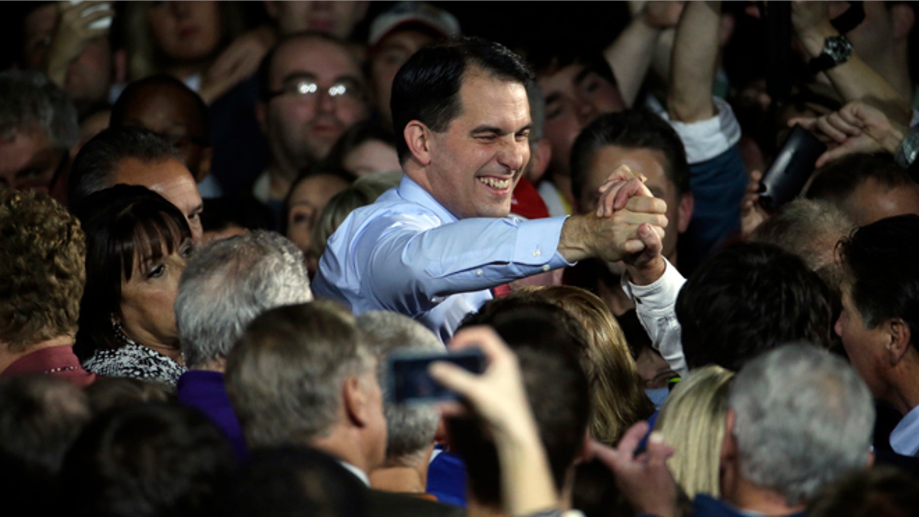 Wisconsin Republican Gov. Scott Walker shakes hands after speaking at his campaign party Tuesday, Nov. 4, 2014, in West Allis, Wis. Walker defeated Democratic gubernatorial challenger Mary Burke. (AP Photo/Morry Gash)
