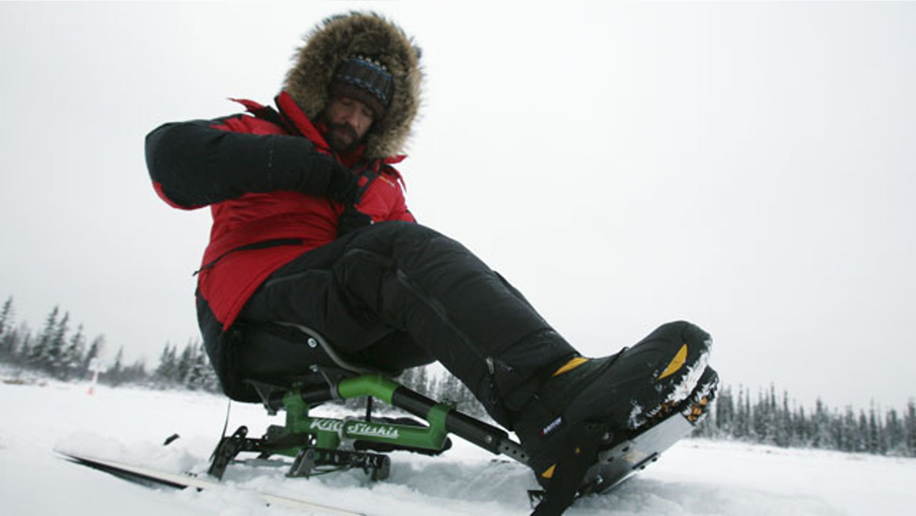 In this Dec. 9, 2011, file photo, Grant Korgan zips up his parka while on his sit-ski before a training run at Smith Lake outside Fairbanks, Alaska.